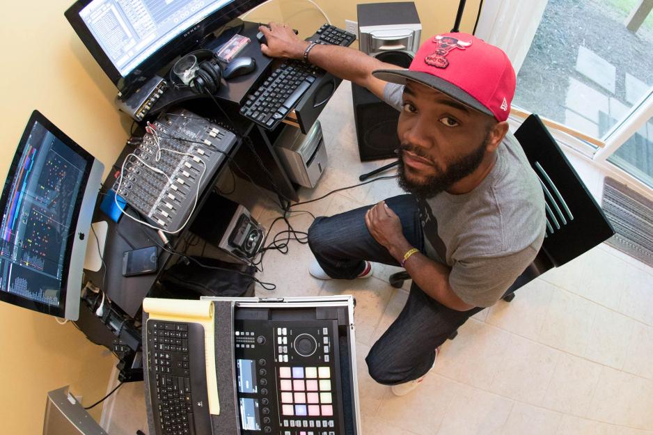 A.D. Carson  looks up to the camera from his computer 