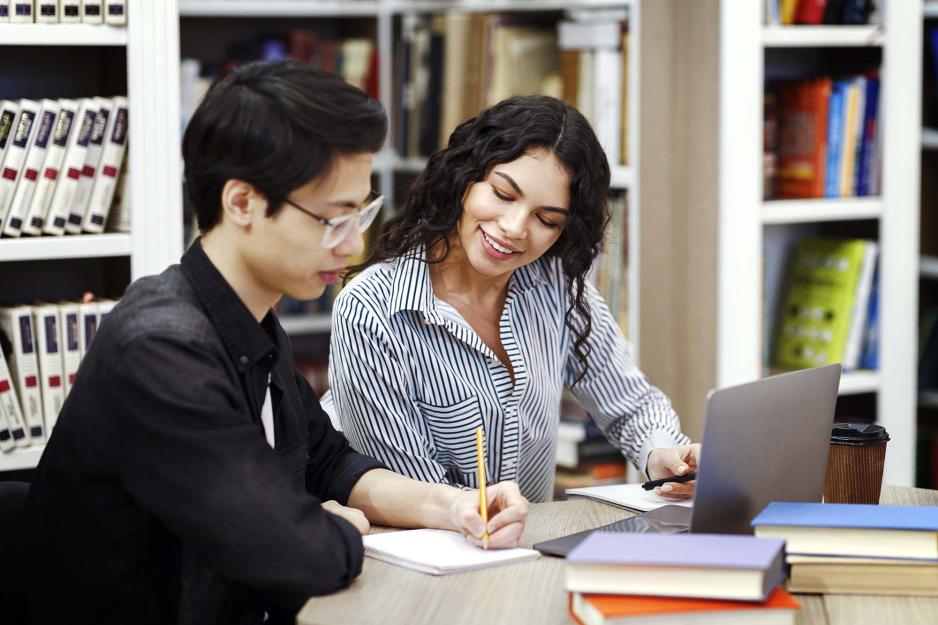 Students sitting at a table together working