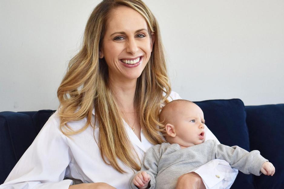 Allie Egan and her baby sitting on a couch