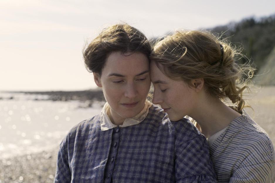 Two women embrace on the beach