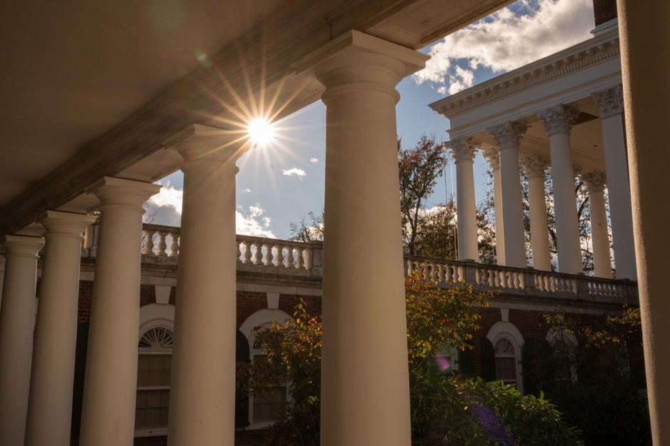 The sun peaking through the top of Rotunda and Lawn walls