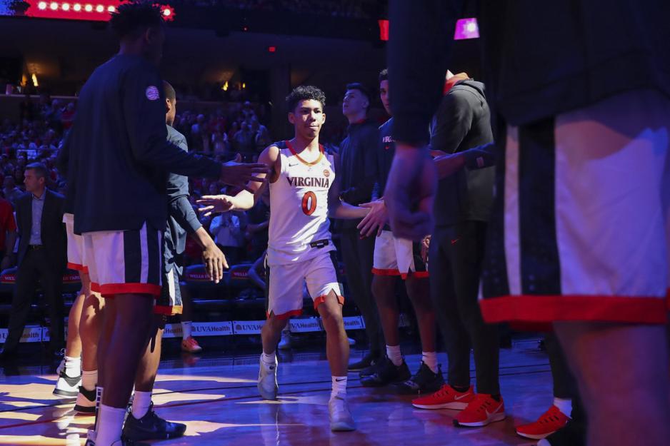 Kihei Clark running between team mates giving fives before the game