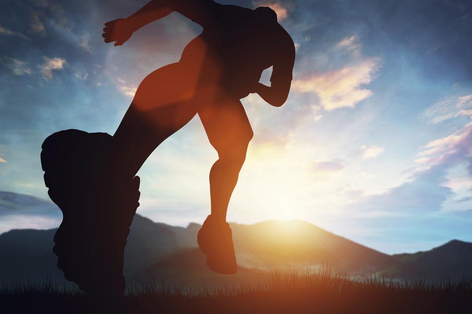 Silhouette of man running into the sunset