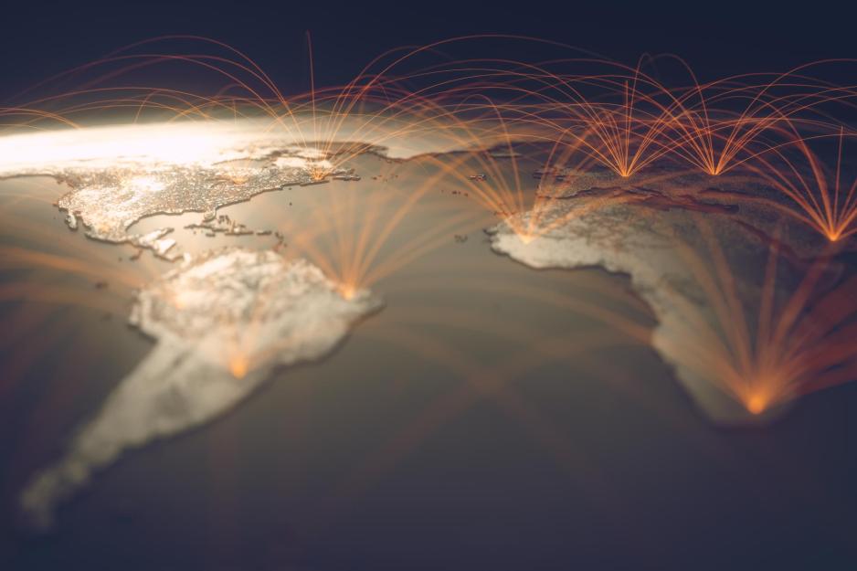 of raised global map slightly arched with orange circles with lines coming out of the circles connecting other dots to each other