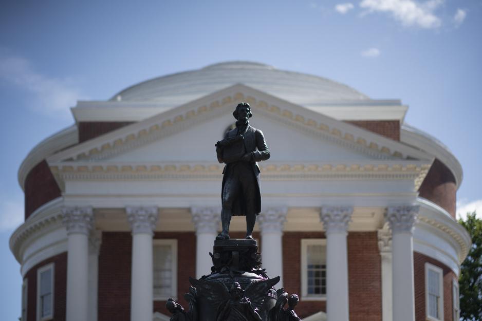 Statue of man standing in from of the Rotunda