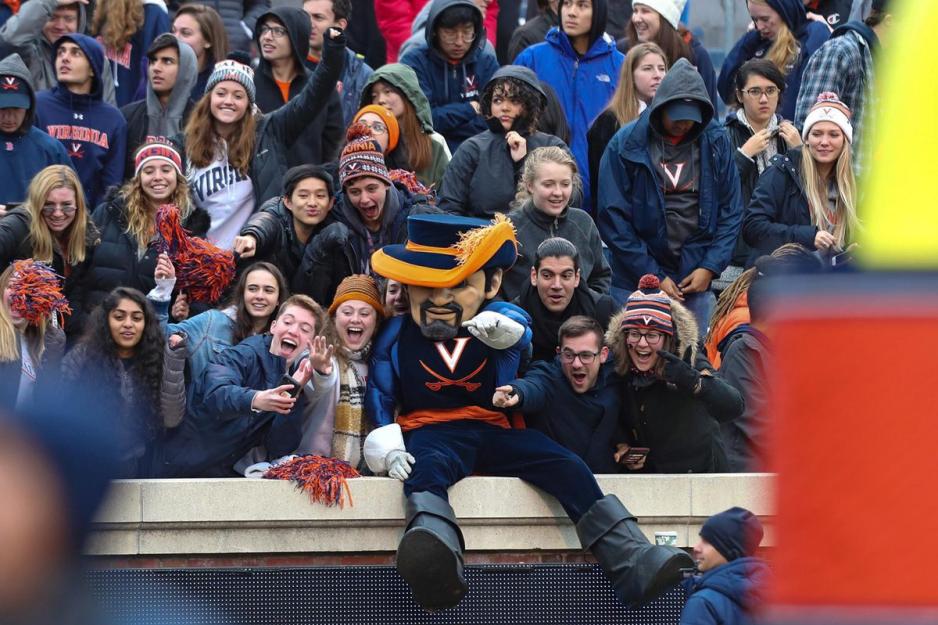 Cav Man on the railing of the stadium with fans cheering all around him