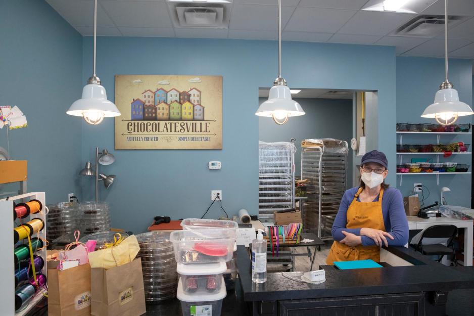 Chocolatesville employee stands near the cash register 