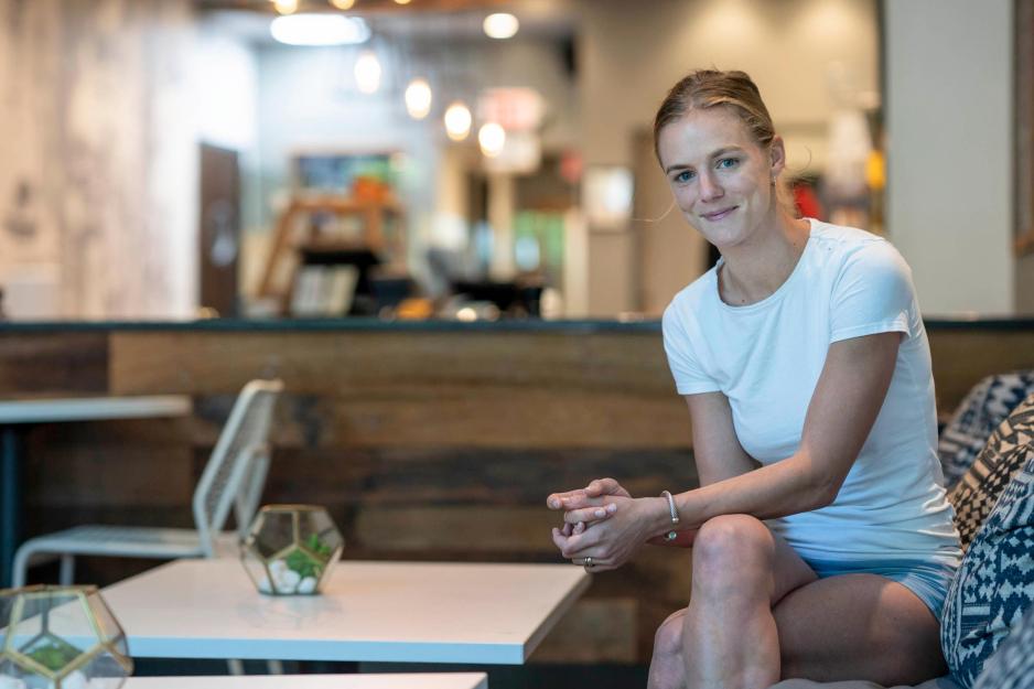 Julie Nolet sits at a table looking at the camera