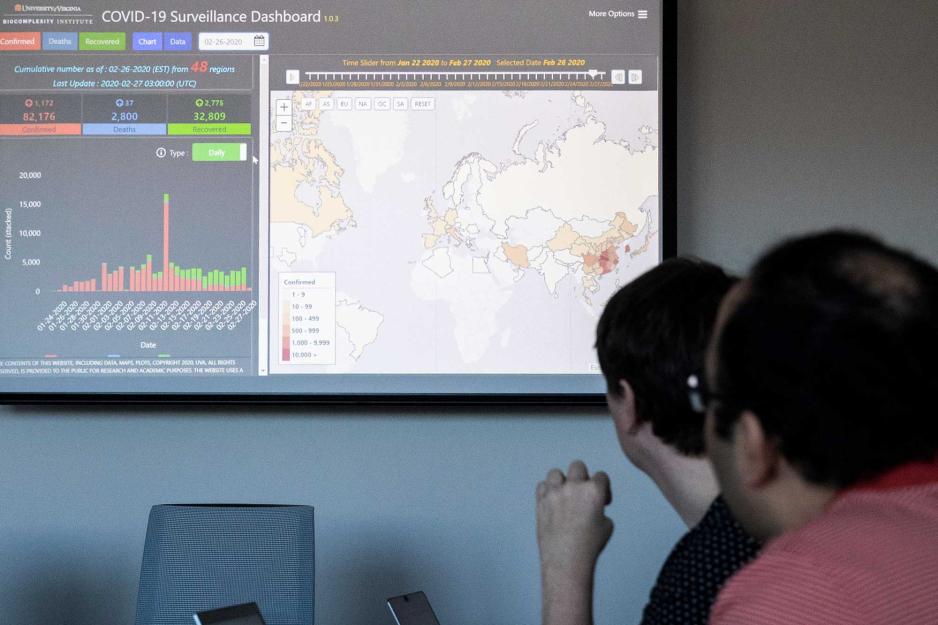 Students looking at a screen with a world map on it