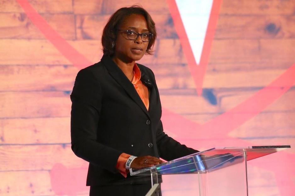 Carla Williams standing at a podium speaking to a crowd