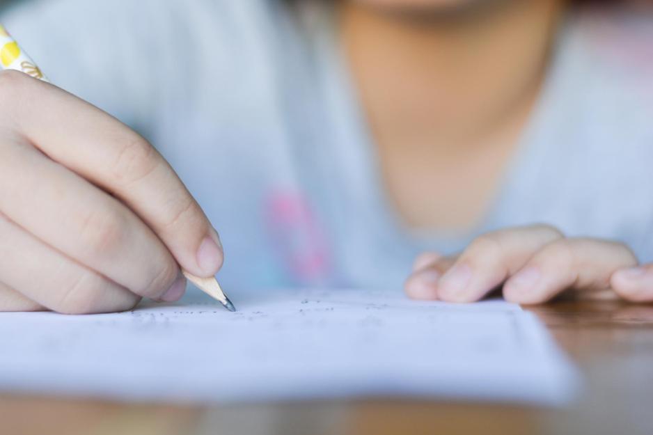 Person writing on a piece of paper