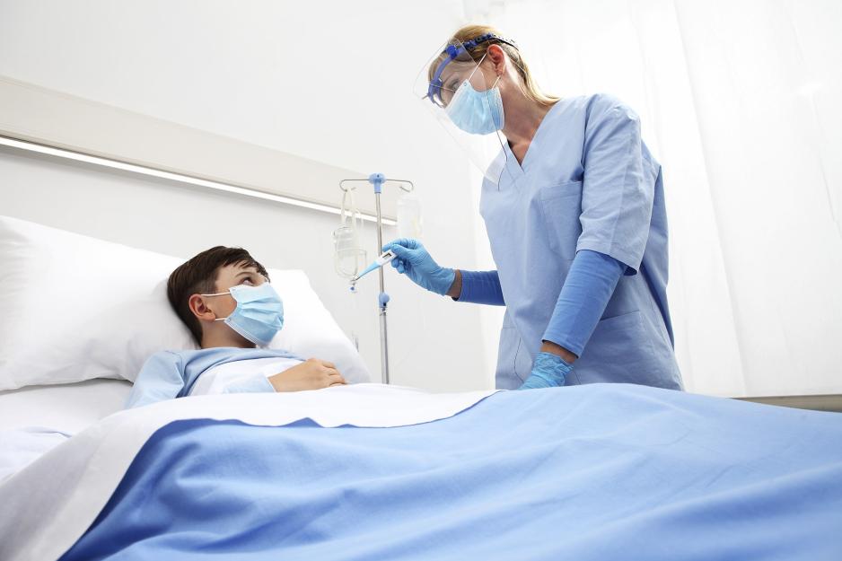 Medical Professional checking the temperature of a child patient