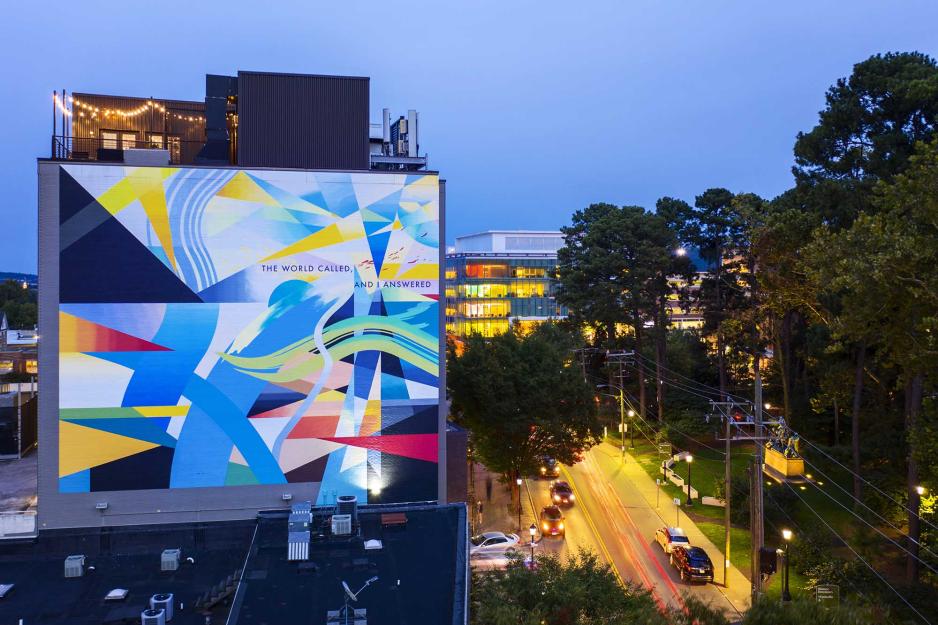 Abstract Mural that reads The world Called, and I answered with random geometric shapes behind the text