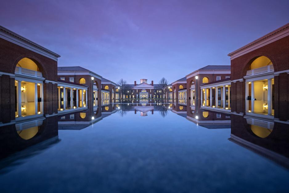 Reflection pond at Darden at dusk with the lights and building reflecting off of the water