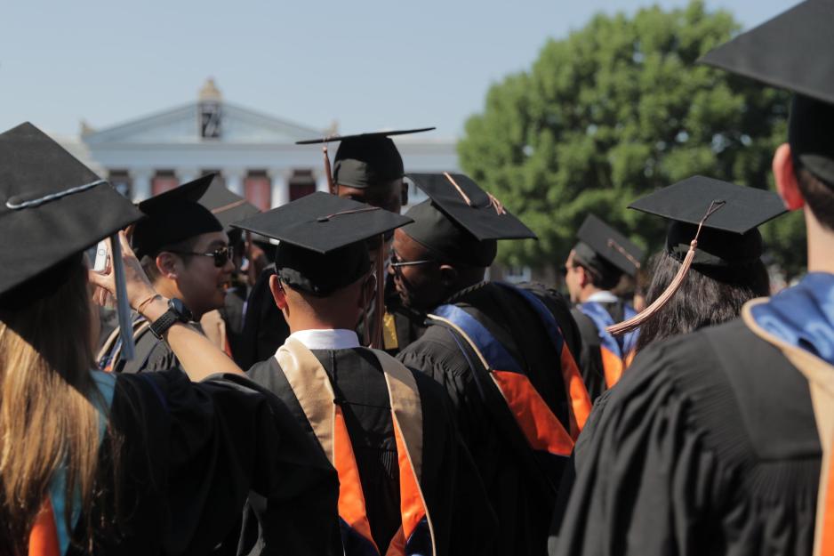 Graduates standing on the Lawn talking