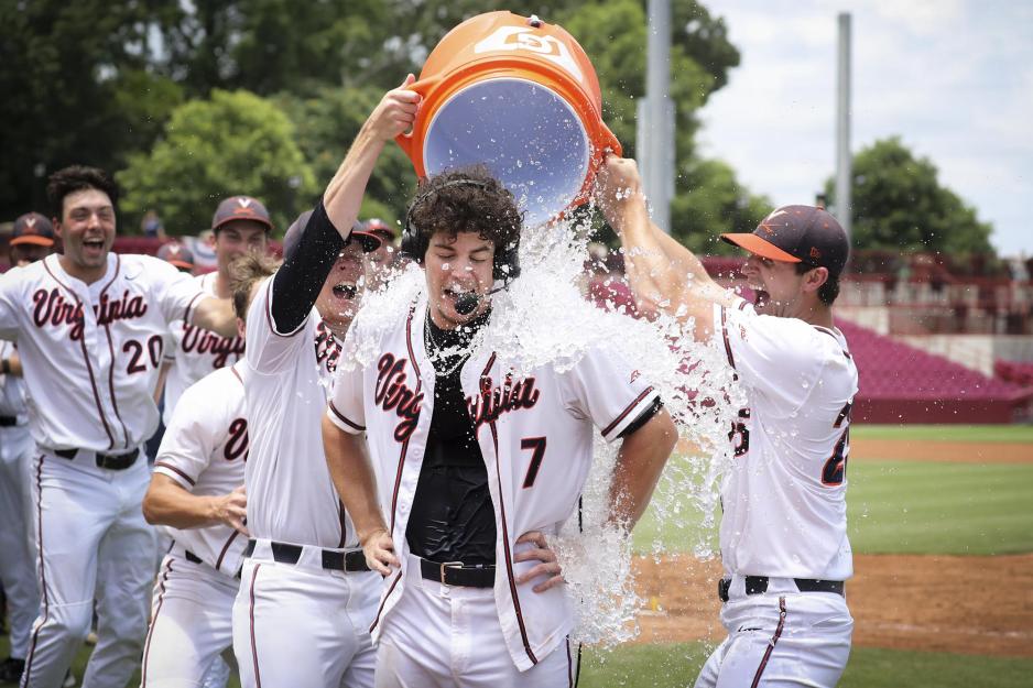 Devin Ortiz giving an interview while his team mates dump ice water on him
