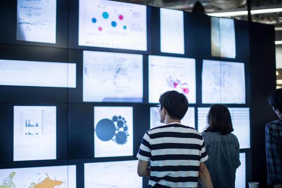 People looking at a wall of images