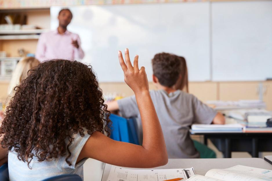 Student in class raising her hand