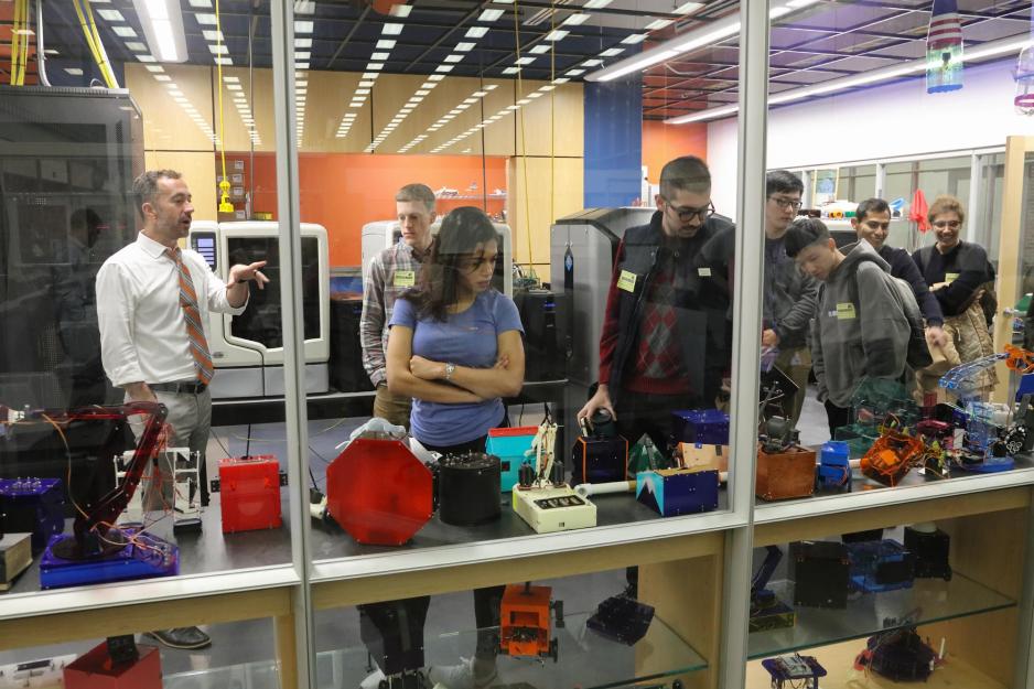 Matthew Shields, left, gives graduate engineering students (from left) Benjamin Bowes, Natalie Lerma, Arash Tavakoli, Ruijie Zhu, Wenqiang Chen, Luis Lopez Ruiz and Sonia Baee a tour the Sigma Lab.