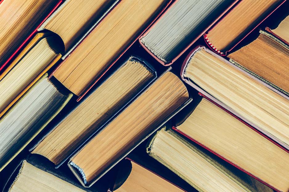 Books on end so that you can see all of their pages.  Books are going in various directions