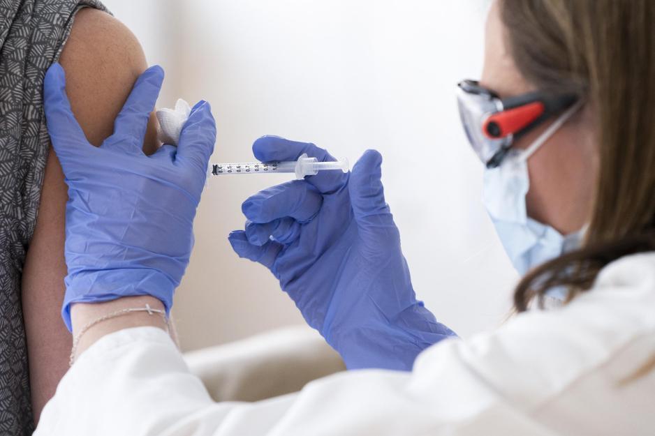 Healthcare professional giving a patient an injection