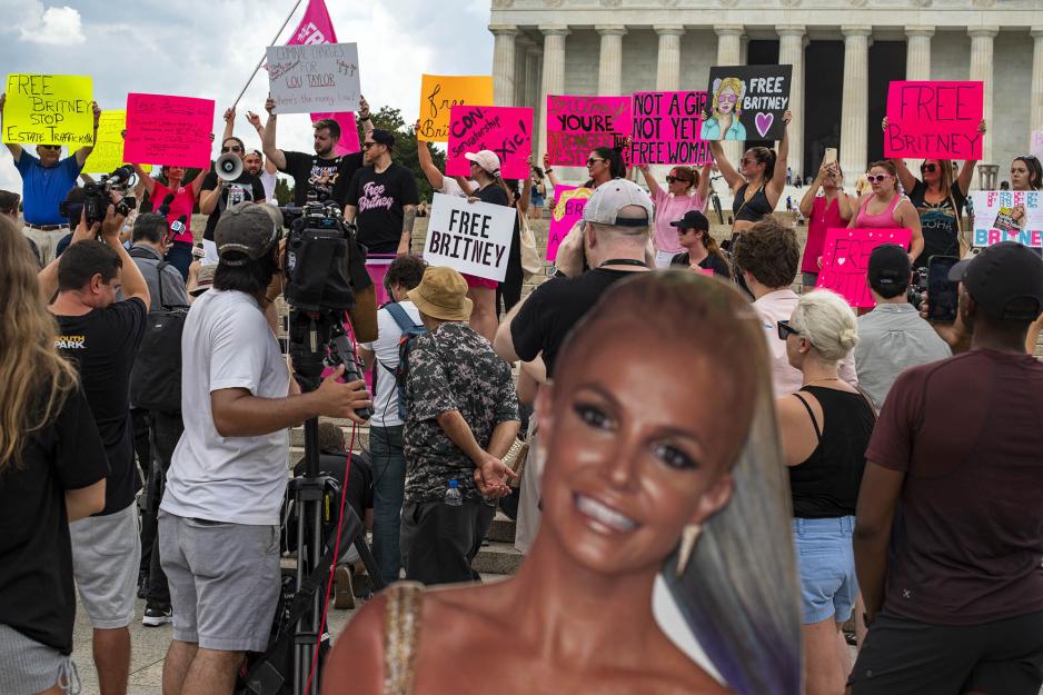 Group of people protesting holding signs that say free Britney