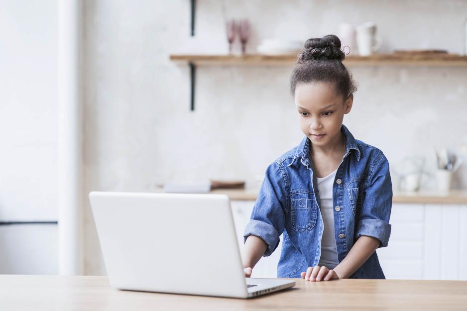 Child working on a laptop at a table