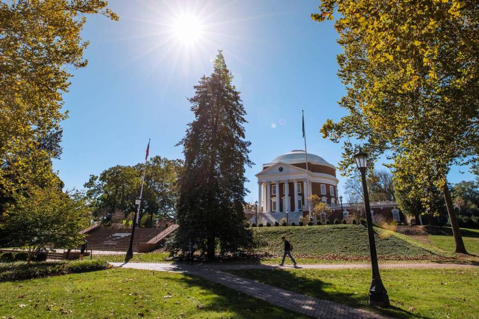 Rotunda from a distance while students walk on the sidewalk in front of it