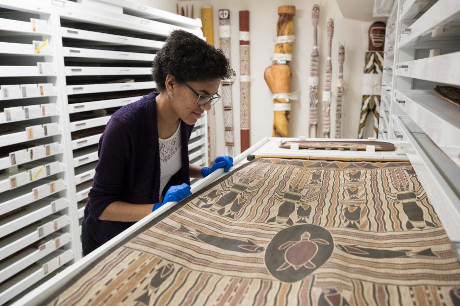Gabby Fuller examining a piece of Aboriginal art