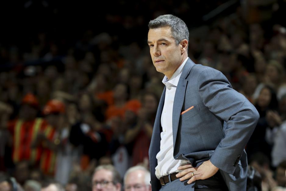 Coach Tony Bennett standing watching his players doing a game