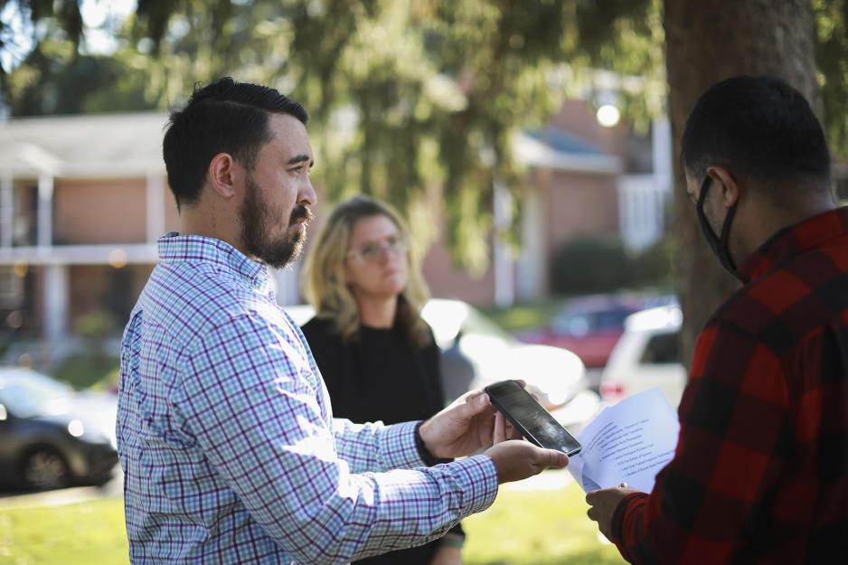 Mike Blochberger, left, Kristin Clarens (center), meet with Afghan refugee