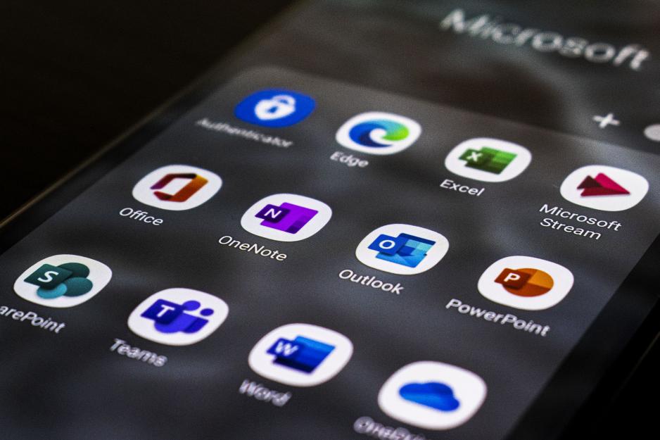 Phone screen with apps visible (Edge, excel, microsoft Stream, office, one note, outlook, powerpoint, sharepoint, teams, word, and oneshare)