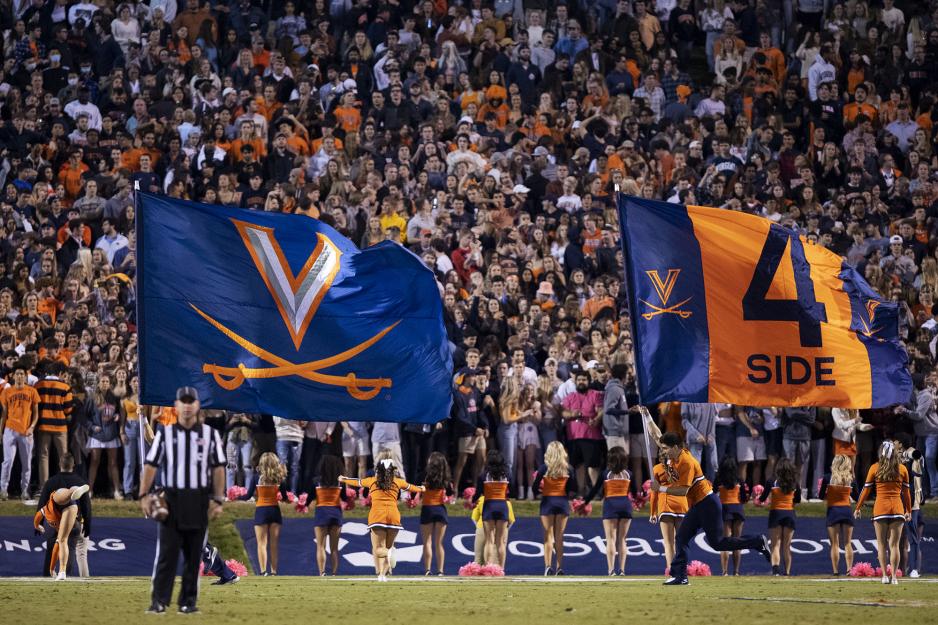 Virginia and 4th side flags being run across the Scott Stadium football field