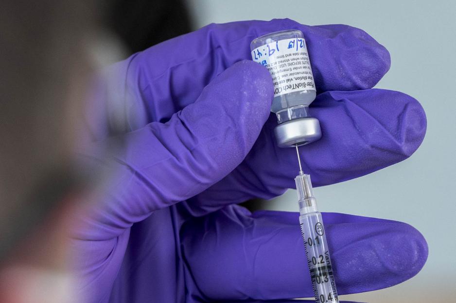 Medical professional drawing up a syringe of the covid-19 vaccine