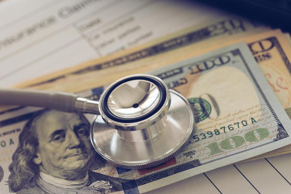 US Money with a stethoscope chest piece on top of it