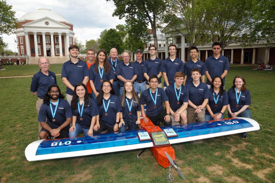 Flying Club pose with their plane for a picture in front of the Rotunda