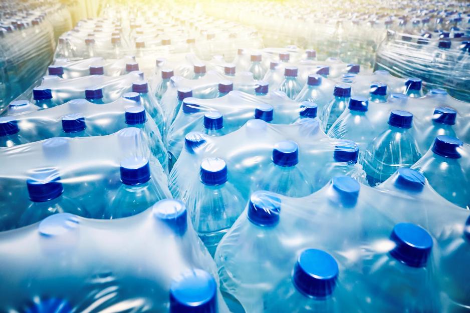 close up of a Room full of Plastic Wrapped six packs of bottled water