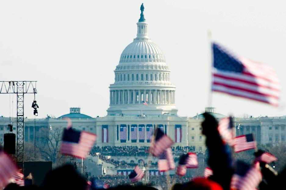 The capital grounds filled with people and American Flags during an Inauguration 