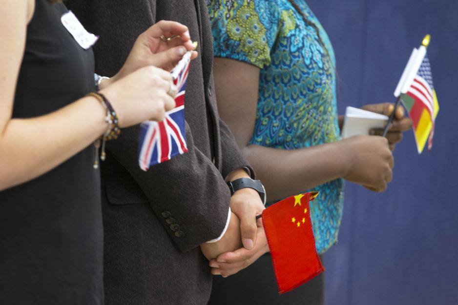 Students holding different mini country flags