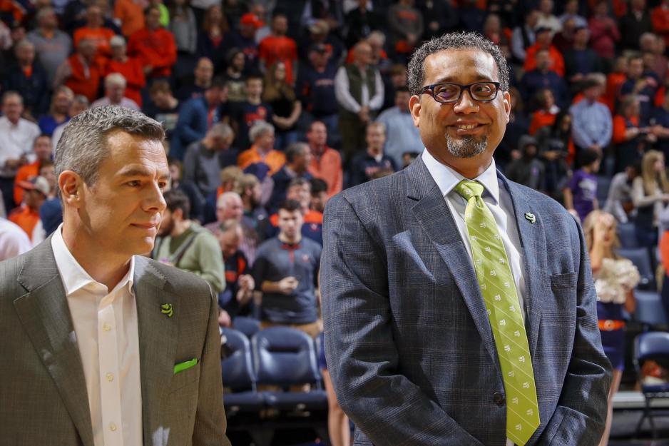 Jason Williford, right, stands next to Tony Bennett on the basketball court