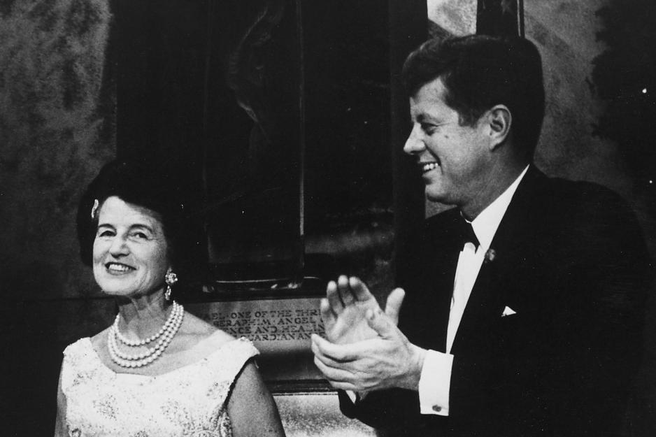 John F Kennedy clapping while looking at his mother, Rose Kennedy, left