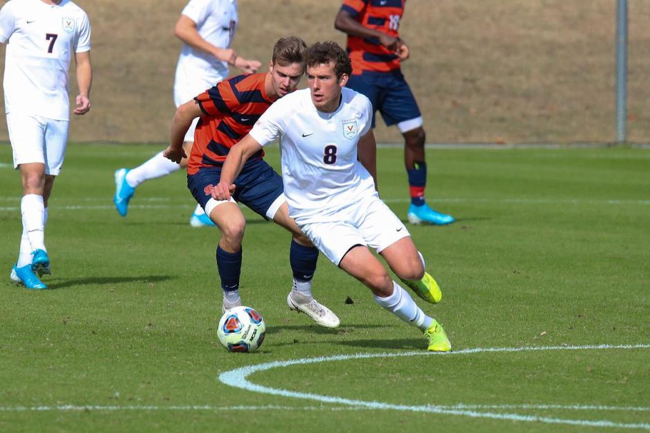 Junior Joe Bell running with the soccer ball down the field