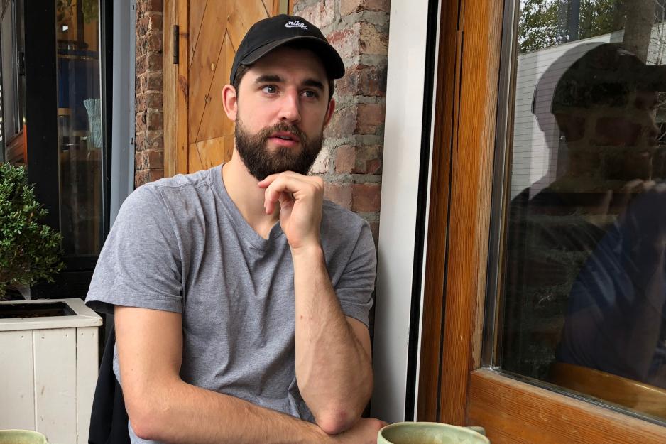 Joe Harris sitting at a table drinking coffee