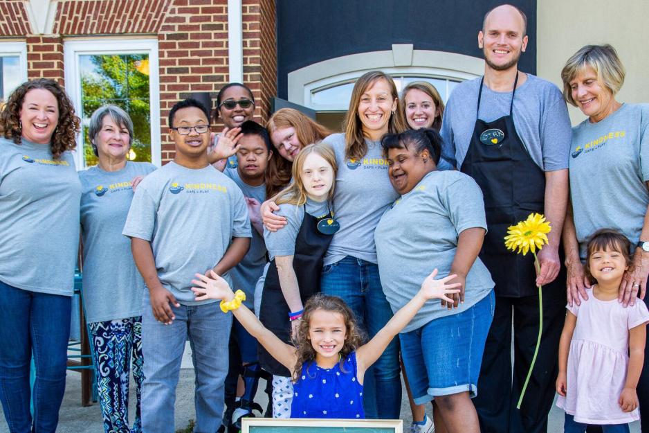 Katie Kishore, center, poses with many children and adults