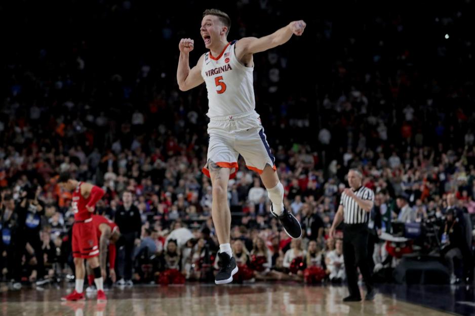 Guy jumping in the air in celebration of the basketball teams victory