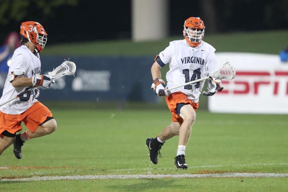 Alumnus Matt Dziama (14) running down the lacrosse field during a game