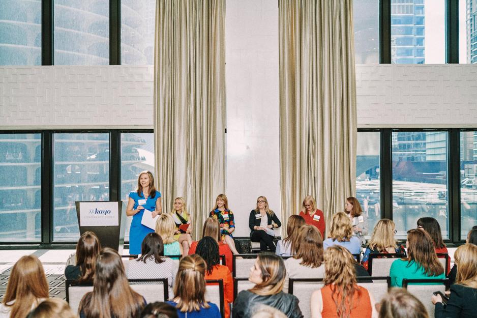 Lindsey Burton stands and talks to a room filled with women
