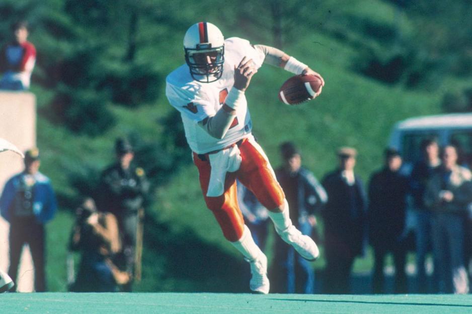 Vintage photo of Majkowski running with the football down the field during a game