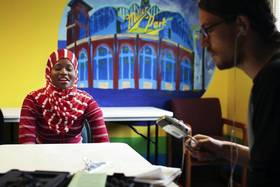 Student interviewing a Washington Park Neighborhood resident at a table