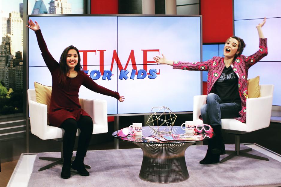 Olivia Pavco-Giaccia, right, and another woman sitting in two chairs on the set of Time for Kids